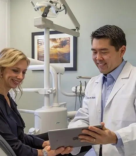 Dr. Lee showing a patient her images on a tablet, chair-side.