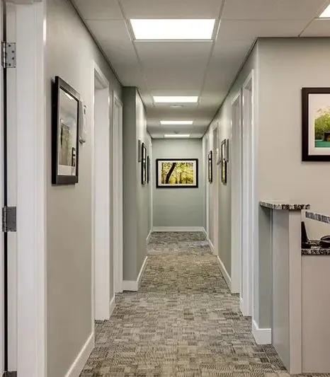The corridor to the treatment rooms, hung with landscape photographs.